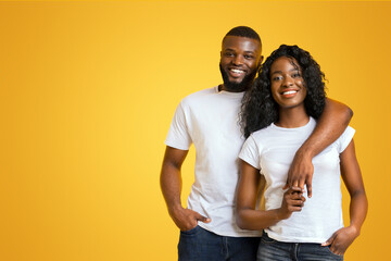 Wall Mural - Young Afro Couple Cuddling, love is in the air, yellow background