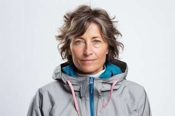 Poster - Portrait of a tender woman in her 50s wearing a functional windbreaker isolated on white background