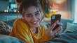 © Nijat - Sending happy messages. Lovely young lady lounging on the couch at home, grinning as she uses her smartphone