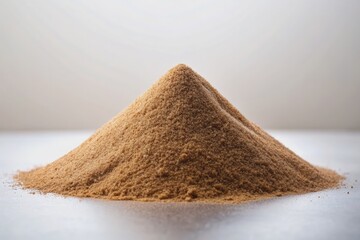 Wall Mural - A dramatic still life composition featuring a mound of warm, earthy brown sand contrasted against a pristine white background, evoking a sense of simplicity.