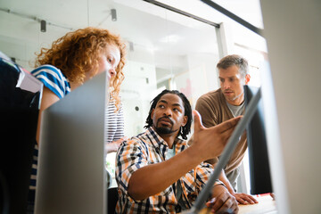 Canvas Print - Collaborative process of multicultural skilled people during brainstorming meeting in office