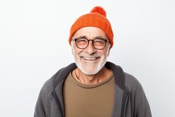 Wall Mural - Portrait of a happy man in his 70s sporting a trendy beanie over white background