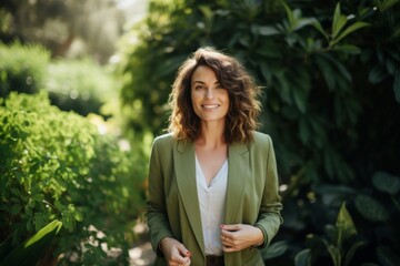 Sticker - Portrait of a joyful woman in her 40s dressed in a stylish blazer in lush green garden