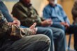 © SKIMP Art - A group of people sitting in chairs, talking and holding hands for support during therapy or cinema class The focus is on the close-up view of their hands as they share ideas Generative AI