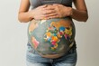 © Антон Сальников - An image of a pregnant woman holding a map of the world on her belly. The concept represents pregnancy, motherhood, preparation, expectations, the future, and climate change.