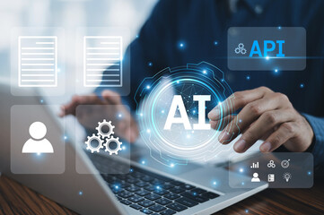 A businessman uses a computer to integrate Application Programming Interfaces (APIs), Artificial Intelligence (AI), and microservices, enhancing operational efficiency and driving innovation.