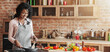 © Prostock-studio - Cheerful young black woman cooking healthy dinner at kitchen, homemade food concept, copy space