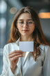 © Daniel - Close-up of Businesswoman Holding Visiting Card in Light Office Background