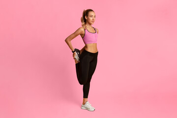 Poster - Sporty Lady Warming Up Stretching Leg Before Workout Training Over Yellow Background. Full Length