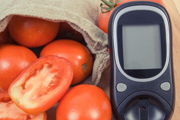 Wall Mural - Glucometer for checking sugar level and fresh ripe tomatoes. Healthy nutrition during diabetes