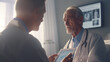 © Natali08 - Doctors discussing patient care using a tablet in a medical office.