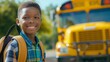 © art-mix - Happy black boy with backpack in front of yellow school bus on sunny day. Concept of back to school