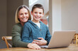 © peopleimages.com - Laptop, education and portrait of mother with child for online learning, school project and lesson. Family, happy and mom with boy on computer for help for research, homework and assignment in home