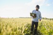 © Serhii - African farmer using a laptop for research rice in organic farm field.Agriculture or cultivation concept