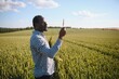 © Serhii - Farmer is standing in his growing wheat field. He is examining crops after sowing