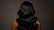 © iamfrk7 - Back view of woman with long wavy black hair, shiny and healthy, beauty and haircare concept, minimalistic dark background