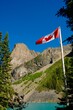 © Designpics - Canadian Flag With Mountains In Background
