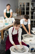 © JackF - Young woman sculpting ceramic product on potter's wheel in workshop