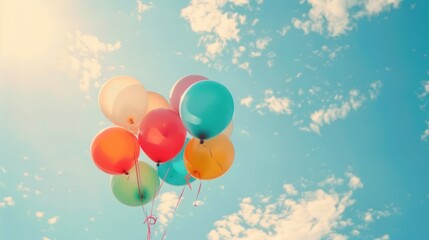 Wall Mural - Multicolored Balloons Floating in a Blue Sky