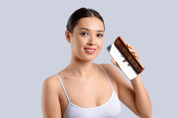 Poster - Young Asian woman with eyeshadows on light background