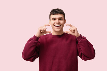 Wall Mural - Young deaf mute man using sign language on pink background