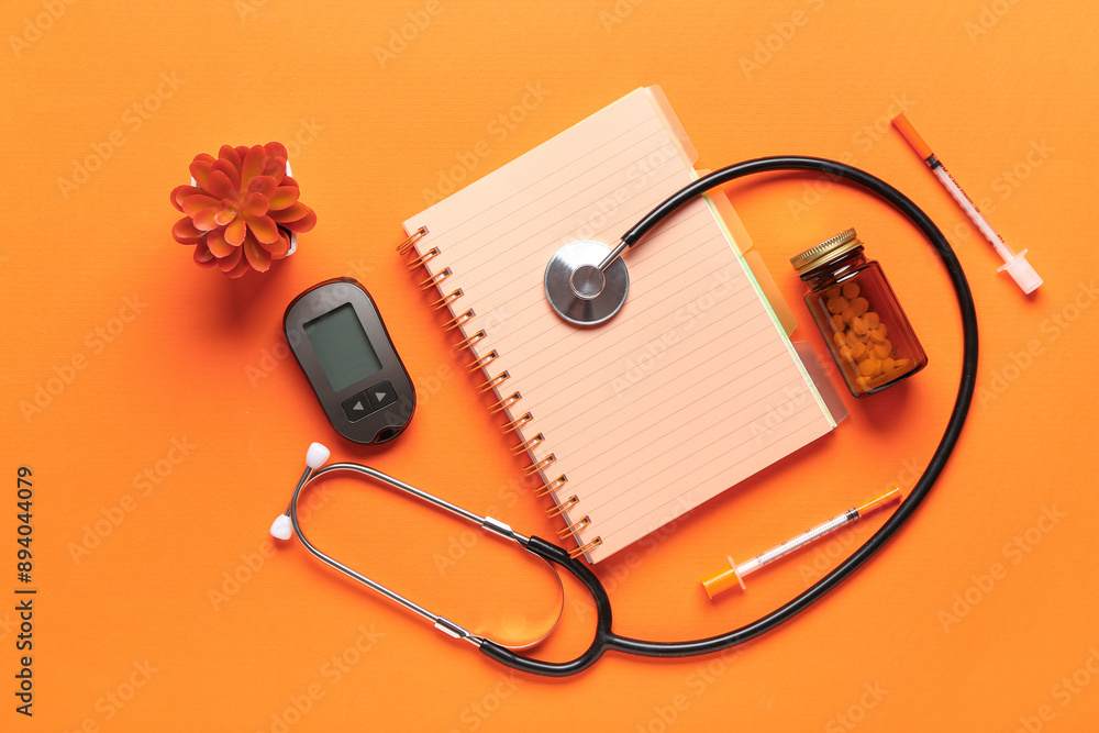 Composition with medical supplies, pills and notebook on orange background