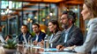 © Phichaphat - Business team discussing strategies at a modern conference table in a bright office environment.