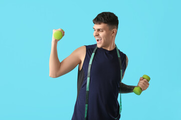 Sticker - Sporty young man with measuring tape and dumbbells on blue background. Weight loss concept