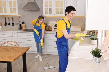 Sticker - Professional janitors working in kitchen. Cleaning service