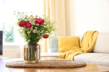 Wall Mural - Beautiful ranunculus flowers and chamomiles in vase on table indoors. Space for text