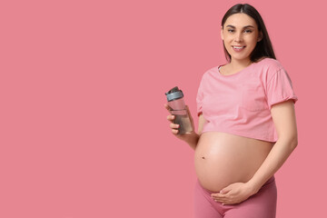 Sticker - Beautiful pregnant woman with bottle of water on pink background