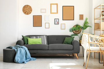 Sticker - Interior of stylish living room with black sofa, houseplants and pictures