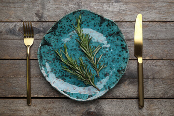 Wall Mural - Modern table setting with cutlery and rosemary on wooden background