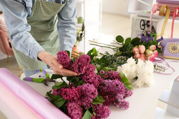 Wall Mural - Female florist with flowers for bouquet in shop