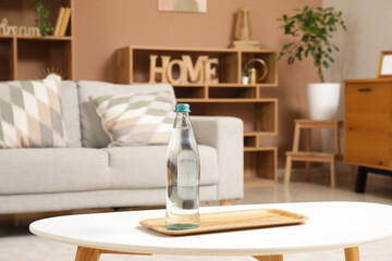 Canvas Print - Bottle of water on table in living room