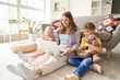 © Pixel-Shot - Cute little children with their mother watching cartoons on laptop at home