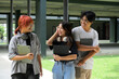 © Parichat - Group of Happy Students Walking and Talking on Campus with Laptops and Notebooks, Enjoying a Sunny Day
