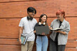 © Parichat - Group of Diverse Students Studying Together Outdoors with Laptops and Notebooks, Smiling and Engaged in Learning