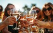 © Vuk - A vibrant image of friends making a toast with glasses of wine outdoors, capturing the essence of friendship, celebration, and togetherness in a joyful, sunlit setting.