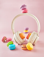 Wall Mural - Colorful Macarons with Headphones on Pink Background