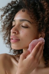 Wall Mural - A woman's close-up of her face being cleansed with a pink scrub, focusing on natural skincare and self care.