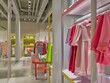 © Mikki Orso - Modern kids  clothing store with vibrant displays of fashionable garments on colorful racks