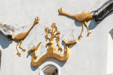 Wall Mural - Title: details of the roof with gold accented decoration on an old house in Luang Prabang, 