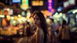 © Wachirasak Jamwimol - Woman in a Bustling Night Market with Colorful Neon Lights
