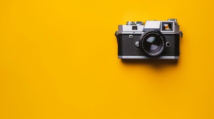 Vintage camera on yellow background.