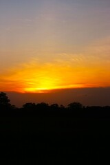 Wall Mural - Sunset Sky Orange Cloud Sunrise Background Evening Golden Hour Blue Dawn Twilight Summer blur Nature Night Horizon Sun Clear Beautiful Clean Cloudy Light Dramatic Bright Calm Yellow Soft Warm Abstract