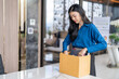 © Charlie's - Quit Job asian business woman sending resignation letter and packing Stuff Resign Depress or carrying business cardboard box in office. Change of job or fired from company