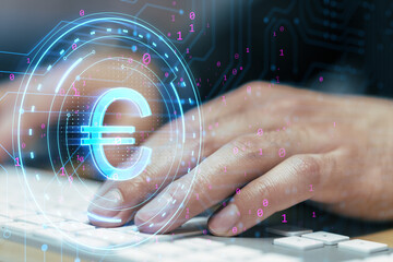 Wall Mural - Close up of man hands using laptop keyboard with digital euro sign on blurry background. Digital banking, technology and cryptocurrency concept. Double exposure.