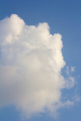 It's a blue sky with atmospheric puffy clouds