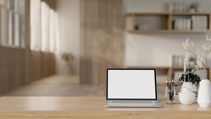 Wall Mural - A laptop computer mockup and accessories on a wooden tabletop in a Scandinavian minimalist room.